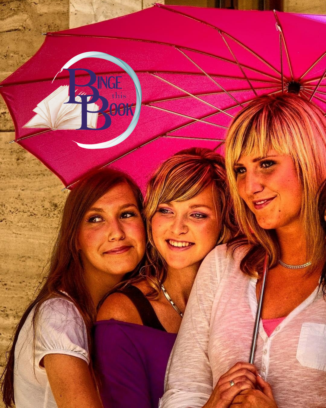 Three adult women smiling under a hot pink umbrella